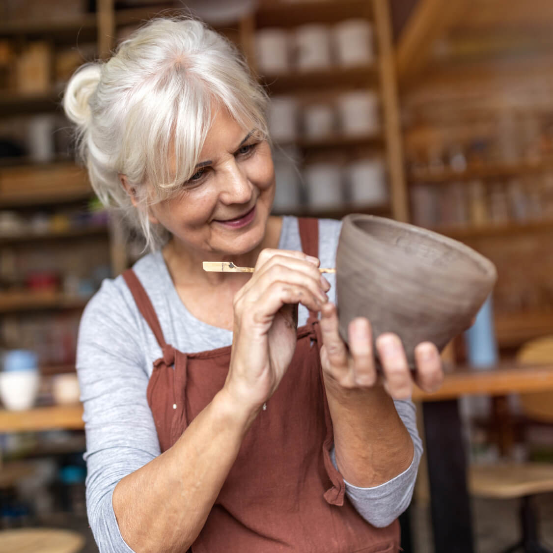 An artist creates a clay mug