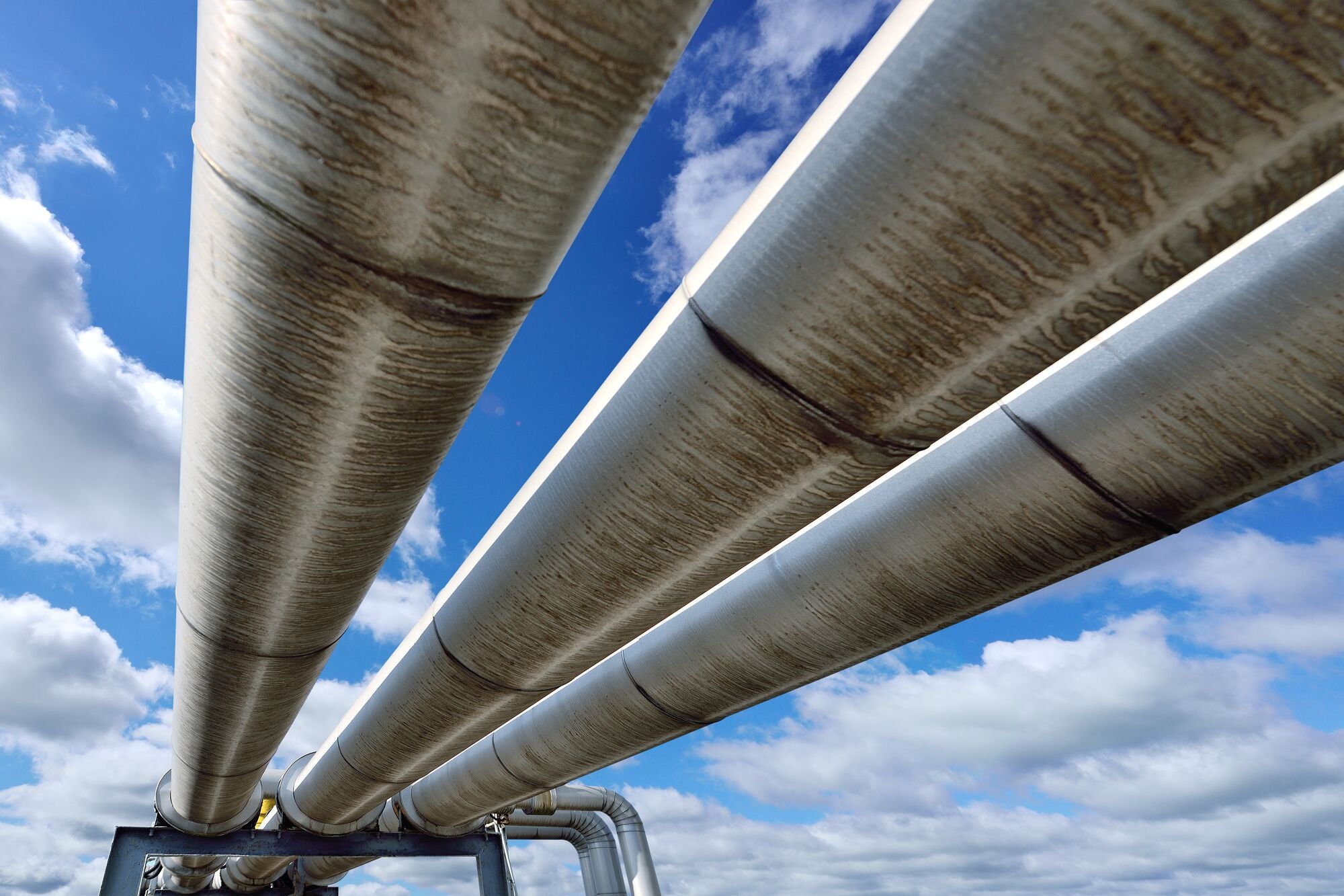Three pipelines reflecting blue sky. (zorazhuang for Getty Images)