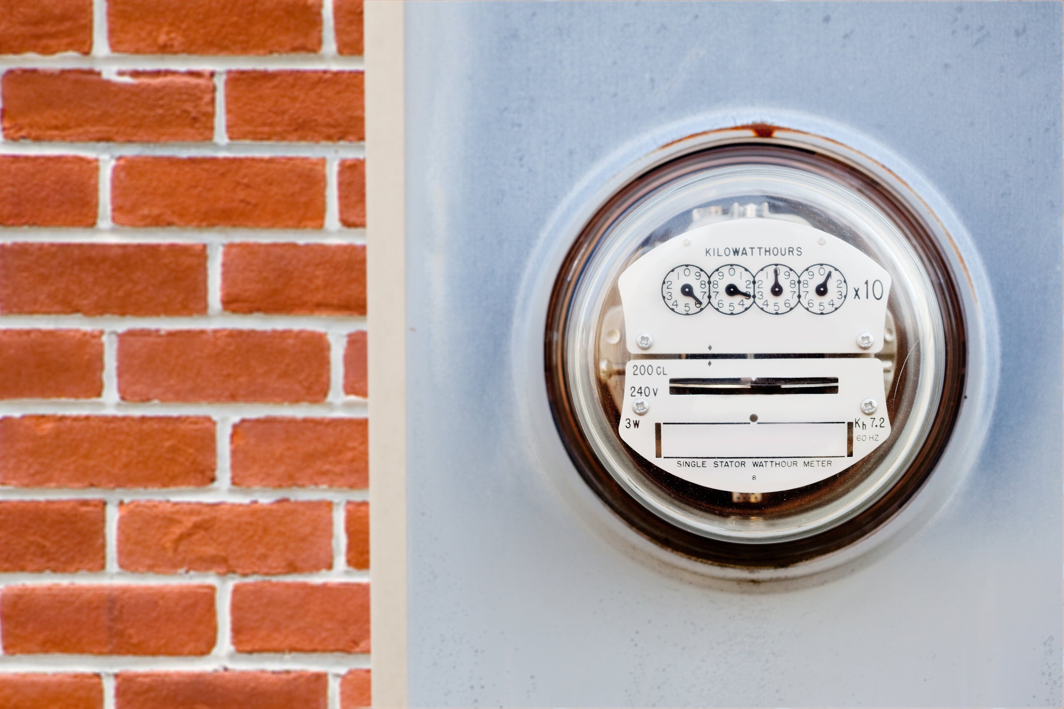An electric meter mounted to the wall.