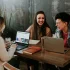 group of people with laptops laughing