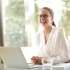 happy woman smiling and sitting at an office