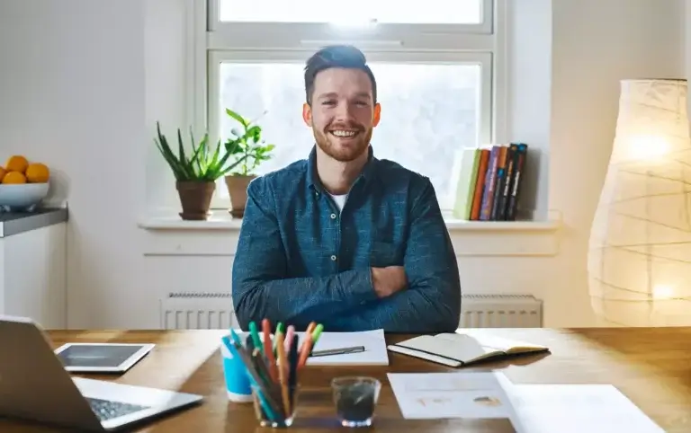 Man with beard sitting at his office