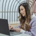 alt text: woman with laptop taking notes